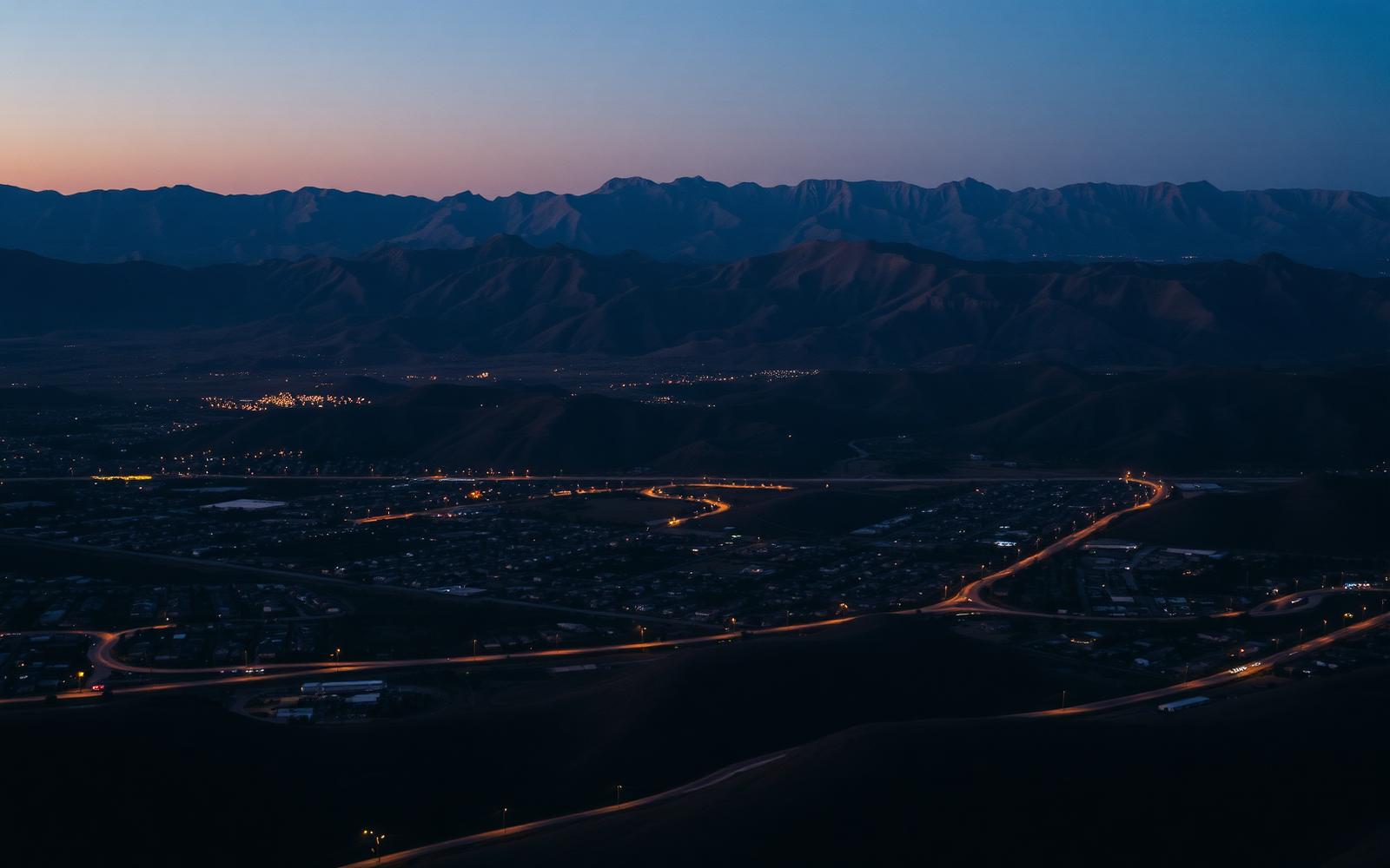 Aerial view of Corona, CA at dusk with the Santa Ana mountains